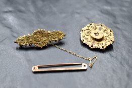Three 9ct gold brooches including plain bar brooch, oval with central diamond chip and bar brooch