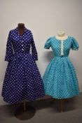 Two 1950s blue spotty cotton dresses, both having full pleated skirts, dark blue dress has button