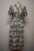 A 1940s floral cotton St Michaels day dress, having cap sleeves, buttons to front, side metal zip