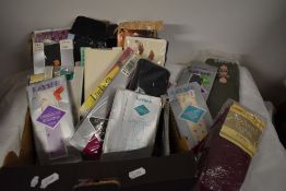 A selection of vintage and retro stockings and tights, most as new in packaging, some very bright