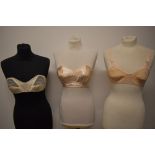 Two 1950s strapless boned bullet bras and a sheer 1950s nylon bra.