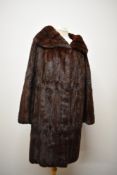 A mahogany ermine 3/4 length coat, in soft and supple condition, medium size.