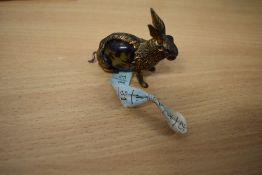 A Victorian cast metal and tortoiseshell novelty tape measure in the form of a rabbit.