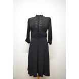 A 1940s dark navy crepe day dress, having 3/4 lace sleeves with crepe band and buttons to cuffs,