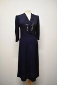 A 1940s navy blue textured crepe day dress, having 3/4 length sleeves, beadwork to bodice and