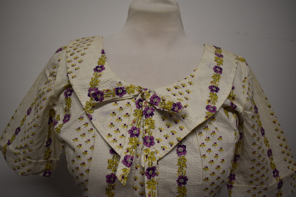 A 1950s textured floral cotton day dress, having statement collar with bow, longline bodice and full - Image 2 of 13