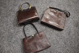 Three vintage brown handbags, including reptile, all having clasp fastenings.