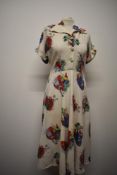 A 1940s vintage cotton day dress, having amazing novelty crinoline lady print, cap sleeves with