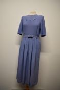 A 1940s lilac crepe day dress, having cut work to bodice, side press stud fastening, belted waist