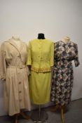 Three 1950s to 1960s dresses, including heavily pleated beige dress with belted waist and huge