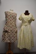 A 1960s floral pinafore dress with two pockets to front and a 1950s pale lemon brocade day dress,