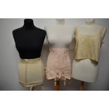 Two vintage girdles, one roll on and the other boned and a 1920s silk camisole.