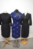 Three 1950s dresses, one having pleated skirt, button accents and embroidery to bodice and belt,