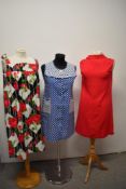 Three 1960s day dresses, including blue and white polka dot dress with pockets to front, floral