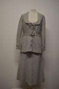 A 1940s dove grey herringbone skirt suit, having low scoop neckline and belted waist to jacket and