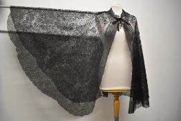 A striking Victorian black tulle lace cape, having silk ties to neckline, amazing detail throughout,