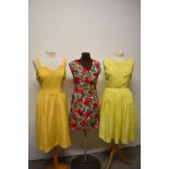 An early 1960s yellow day dress having pleated skirt, a 1960s floral mini dress and a 1950s yellow