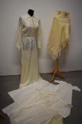 A collection of vintage and antique baby clothing, including embroidered lawn cotton dress and a