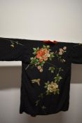 A early 20th century Kimono/jacket, having red velvet lining and extensive silk embroidered