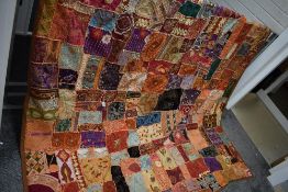 A vintage Suzani wedding quilt of wonderful bright colours, with depiction of the happy couple to