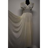 A cream tulle and taffeta evening dress, having lace collar with rhinestone accents, cross over bust