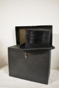 An early 20th century Lock & Co hatters, St James street, London top hat with original carry case.