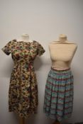 A 1950s floral medium weight cotton day dress and a 1950s floral cotton skirt.