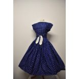 A stunning 1950s Horrockses fashions cotton day dress, having blue ground with white polka dot