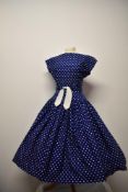 A stunning 1950s Horrockses fashions cotton day dress, having blue ground with white polka dot