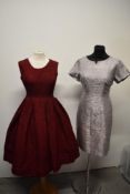 Two vintage 1950s dresses, comprising red textured dress with metallic thread running throughout and