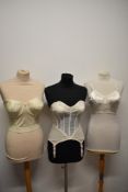 A 1950s strapless boned corselette/ girdle, having lace to cups and 4 suspender clasps, a 1950s