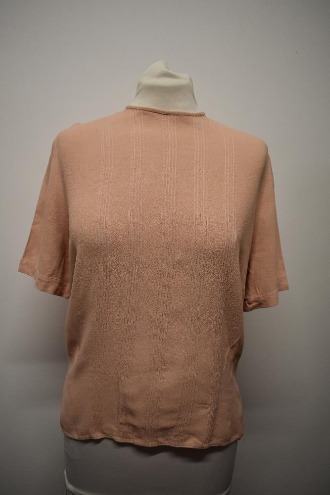 A 1940s blouse in a pale salmon shade, having buttons fastening to reverse and pin tucks to front. - Image 2 of 5