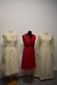 Two 1960s lace dresses, including Vera Mont Paris dress in cherry red and a 1960s wedding dress.