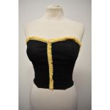 A 1950s black bustier/ sun top, having shirred back with hook and eye fastening.