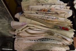 A large assortment of vintage table linen, including table cloths, napkins and tray cloths.
