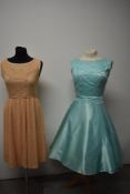 A stunning aqua blue late 1950s early 60s party dress having lace bodice and bow detail to back,