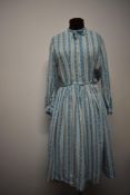 A 1950s vintage 'Polly Peck' cotton day dress, having novelty pattern, full length sleeves, full