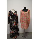 A 1960s floral trapeze dress having long sleeves, gathering into a fitted cuff with buttons and a
