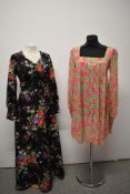 A 1960s floral trapeze dress having long sleeves, gathering into a fitted cuff with buttons and a