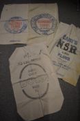 Four vintage feed and flour advertising sacks.