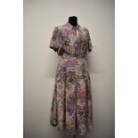 A 1940s silk day dress, having palest pink ground with amazing orchid pattern in various shades of