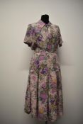 A 1940s silk day dress, having palest pink ground with amazing orchid pattern in various shades of
