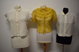 Three 1940s to 1950s blouses, including crocheted blouse and mustard yellow blouse with ruffles to