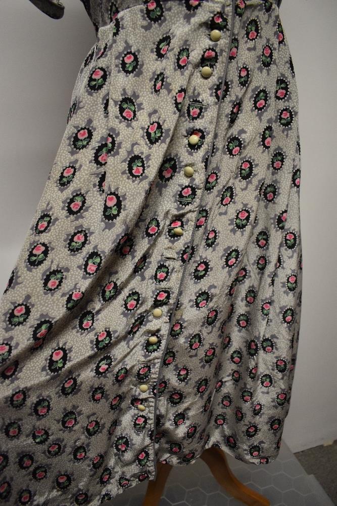 A 1940s floral day dress in a silky (most probably rayon) fabric, having buttons to front, a few - Image 2 of 7