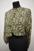 A 1930s floral crepe blouse, having bow to neckline and long sleeves, has been historically