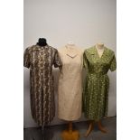 Three vintage dresses comprising; sage green dress with pleated skirt circa 50s/60s and two 1960s