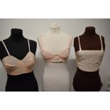Two 1930s bralettes and a 1930s bra.