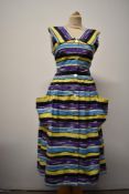 A vibrant 1950s cotton sun dress, with yellow, purple, blue, white, yellow and black abstract stripe