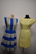 Two 1950s day dresses, to include; blue and white floral textured cotton dress with pleated skirt