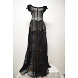 A striking Art Deco cotton tulle evening gown in black, having elasticated sleeves with velvet bow